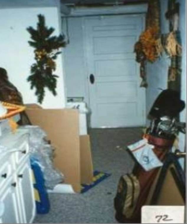Crime scene photo taken on December 26, 1996 shows the white door leading to the wine cellar where JonBenét's body was discovered under a blanket