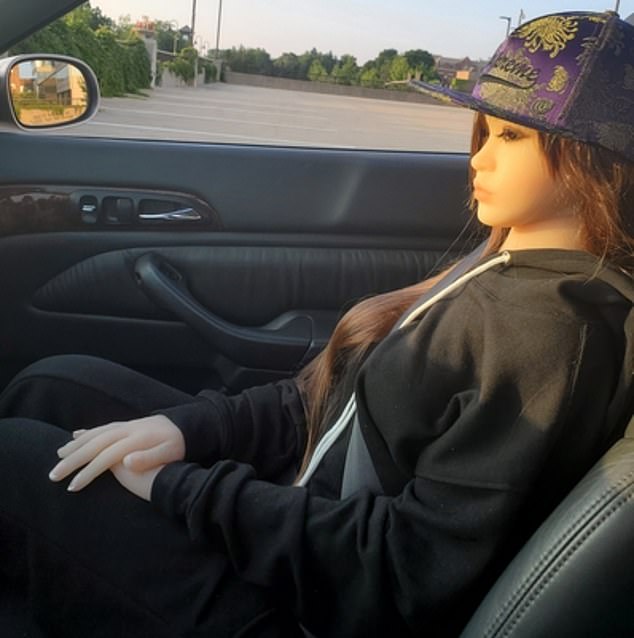 Online, Robert 'Bobby' Crimo often shared photos of his teenage sex doll, including this one from June 2020 showing the doll he named 'Sophie' sitting in the passenger seat of his car
