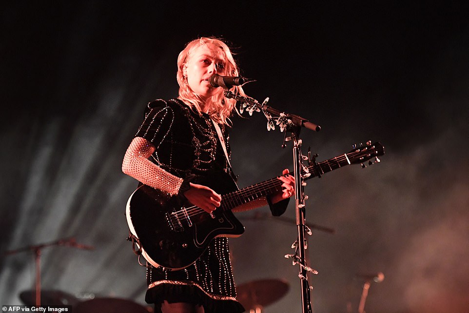 Dressed for the occasion: Phoebe Bridgers opted for a black sequin dress that was contrasted with a set of white sleeves during her time behind the microphone
