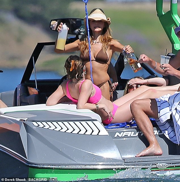 Unión familiar: la estrella de YouTube, de 22 años, usó un diminuto bikini marrón mientras celebraba las vacaciones con su hermana Bella, de 23 años, en un bote en Coeur d'Alene, Idaho.